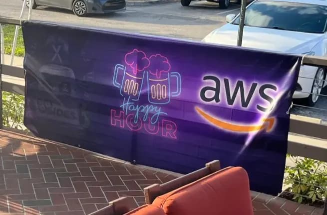 AWS-sponsored neon Happy Hour banner at BSides Tampa 2023
